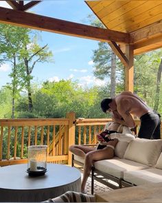 a man and woman are sitting on a porch