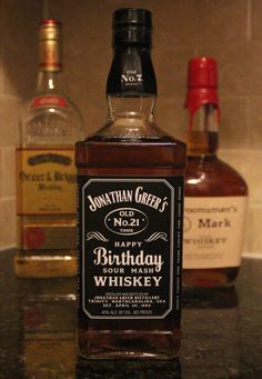 a bottle of birthday whiskey sitting on top of a counter