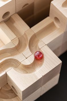 a red object sitting on top of wooden blocks