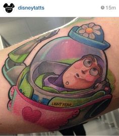 this is an image of a cartoon character in a space ship tattoo on the arm