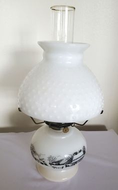 a white vase sitting on top of a table