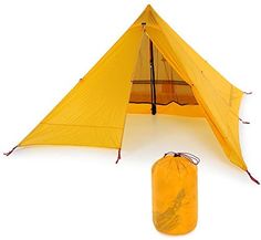 a yellow tent with a sleeping bag next to it on a white surface and an object in the foreground