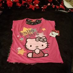 Hello Kitty Girls Sleeveless Top Approximate Flat Measurements 15" Pit/Pit 22/20" Hi Lo Length Questions? Leave A Comment Below! Playful Sleeveless Top With Hello Kitty Print, Casual Hello Kitty Print Tops For Sleepover, Stretch Short Sleeve Tops For Sleepover, Cute Hello Kitty Print Tops For Sleepover, Cute Hello Kitty Tops For Sleepover, Stretch Pink Tops For Sleepover, Fitted Sleeveless Tops For Sleepover, Playful Sleeveless Top For Sleepovers, Pink Flannel Shirt