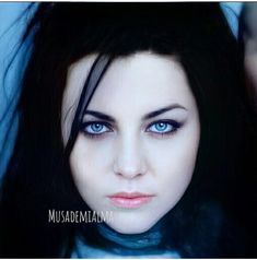 a woman with long black hair and blue eyes