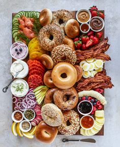 an assortment of doughnuts and fruit on a platter