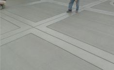 a man standing on top of a cement floor next to a white fire hydrant