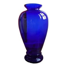 a large blue vase sitting on top of a table