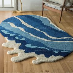 a blue and white area rug with waves on it