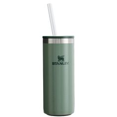 a green tumbler with a straw in it and the word stanley written on it