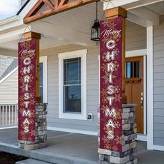 two christmas banners on the front porch of a house