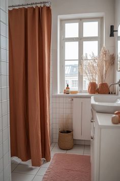 a bathroom with two sinks and a shower curtain