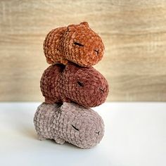 three crocheted teddy bears stacked on top of each other