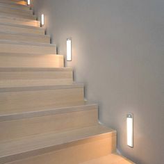 a set of stairs with two lights on each side