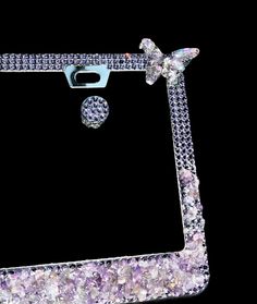 a cell phone case with a bow on the front and diamond details in the back