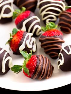 chocolate covered strawberries are arranged on a white plate