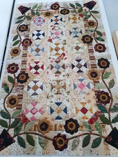 an old quilt is laying on the floor