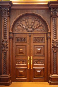 two wooden doors with ornate carvings on the front and side panels, one is open