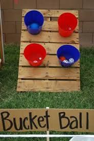 buckets and bowls are on display in front of a sign that says bucket ball