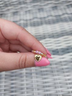 Homemade beaded ring with heart charm! Gold Heart Jewelry With Colorful Beads, Gold Heart-shaped Jewelry With Colorful Beads, Dainty Heart-shaped Jewelry With Colorful Beads, Heart-shaped Colorful Beads Jewelry For Gifts, Heart Pendant Jewelry With Colorful Beads For Gift, Colorful Heart-shaped Beaded Jewelry, Heart Shaped Beaded Jewelry Gift, Heart Shaped Tiny Beads Jewelry Gift, Heart-shaped Tiny Beads Jewelry Gift