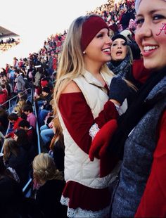 two girls with face paint at a sporting event