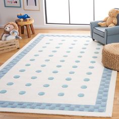 a blue and white rug in a child's room with teddy bears on the floor