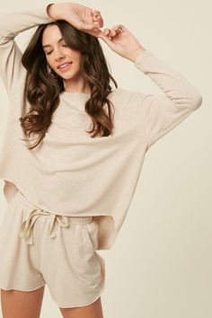 The perfect casual choice for lounging around or stepping out! -Color: Champagne -Round neck -Drop shoulder, long sleeves -High and low hem top -Drawstring waist with tie string -Pockets on pants -Lined -Imported -Content: 50% Polyester 40% Cotton 10% Rayon -Model is 5' 10" 32-26-35 and wearing a size Small 2024 Manifestation, Knitted Loungewear, Cozy Sleepwear, Pajama Fashion, Homewear Woman, Color Pallete, Hello December, Cotton Sleepwear, Manifestation Board