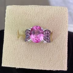 Pretty Ring With One Large Stone And Several Pink Accent Stones On The Side. Rhodium Over Sterling Silver. Romantic Rings, Tanzanite Diamond Ring, Pretty Ring, Pink Tourmaline Ring, Tanzanite Diamond, Large Stone, Bow Ring, Pave Diamond Ring, Pattern Ring