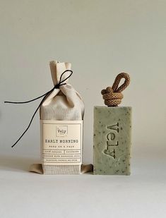 a soap bottle next to a rope wrapped bag