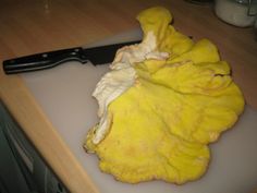 a knife and some food on a cutting board