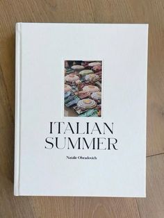 the book italian summer is sitting on a wooden table