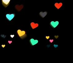 many different colored hearts in the dark