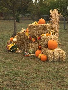 a hay bale with pumpkins and gourds on it