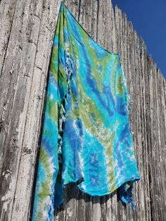 SEAWEED Tie Dye Beach Sarong in 3 Sizes Hand-Dyed Beach Cover Up Vibrant Beach Sarong Hand-dyed super lightweight beach sarong or wall tapestry.  Wrap it around your hips, or cover your shoulders with it. Color Combo Name: SEAWEED avocado, denim, aqua If you are on SM,  Please follow me! HTTP;//instagram.com/vacationwardrobenyc HTTP;//facebook.com/tiedyeagi This is a new Style, and comes in 3 sizes! To tie it up as modeled on a size L and up frame, you will need the 88½" length - Extra long. Zoey is a size XL, I gave her a regular length to model - she was not able to tie the ends behind her neck. It is a very lightweight woven rayon fabric sarong with fringes along the shorter sides. The colors are vibrant, bright, & gorgeous; pink and orange!  This sarong measures  Regular: 58" X 43½" Lo Green Bohemian Sarong For Vacation, Casual Green Sarong For Beach Season, Bohemian Green Sarong For Pool, Blue Beach Season Cover-up For Warm Weather, Blue Summer Cover-up For Warm Weather, Green Bohemian Sarong For Poolside, Green Bohemian Sarong For Summer, Bohemian Green Sarong For Poolside, Bohemian Green Sarong For Beach Season