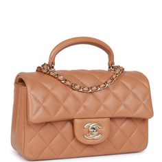 This Mini Rectangular flap bag with top handle is in Caramel quilted lambskin leather with light gold tone hardware, front flap with CC turnlock closure, half moon back pocket and interwoven light gold tone chain link and Caramel shoulder/crossbody strap. The interior is lined in caramel leather and features one zip pocket on the rear wall with logo pull and one open pocket on the rear wall underneath zip pocket. Collection: 23P (RFID Chip) Origin: Italy Condition: Pristine; new Accompanied by: Chanel Mini Rectangular, Chanel Classic Flap Bag, Chanel Box, Classic Flap Bag, Chanel Mini, Gold Chanel, Lk Bennett, Rene Caovilla, Pierre Hardy