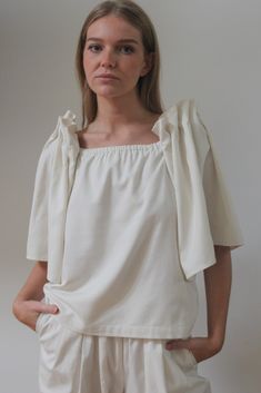 The Talu Top is a stunning blouse created from our most coveted fabric to date - our warm and structured, Silk Canvas. The Talu features dramatic open bell sleeves with intricate accordion pleat detailing, yet is balanced with a straight-forward body that can be worn tucked into favorite in-house trousers or worn over a classic dress such as our Rose Slip Dress. Made in USA Simple Tote, Ribbed Knit Dress, Wide Leg Linen Pants, Double Breasted Blazer, Classic Dress, Linen Shirt, Knit Dress, Best Sellers, Jumpsuit Dress