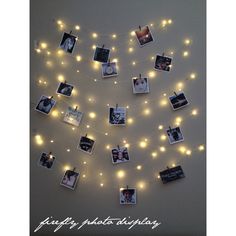 a string of lights with pictures hanging from it's sides and photos on them