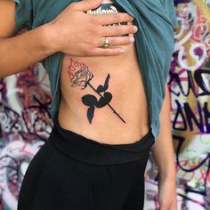 a woman with a rose tattoo on her stomach