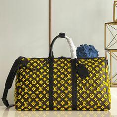 ellow Flocked Travel Bag Series Louis Vuitton Men's Artistic Director Virgil Abloh interprets classic travel bags with interesting geometric shapes, creating a yellow Monogram Tuffetage canvas version of the Keepall Triangle BANDOULIÈRE 50 travel bag. The triangular shape is complemented by a pair of smooth leather top handles and side straps that complement the yellow Monogram embroidered background. This travel bag holds a variety of travel essentials. 

Detailed features 51 x 30 x 28 cm (le Designer Coated Canvas Rectangular Duffle Bag, Designer Brown Bag For Trips, Designer Rectangular Coated Canvas Duffle Bag, Designer Duffle Bag For Daily Use, Luxury Yellow Rectangular Bags, Luxury Yellow Tote Bag, Designer Monogram Canvas Duffle Bag, Designer Rectangular Bags For Trips, Designer Rectangular Coated Canvas Travel Bag