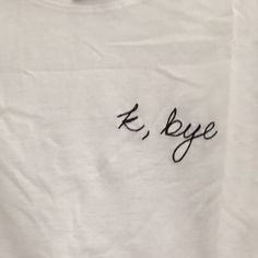 a white t - shirt with the word e bye written on it in cursive writing