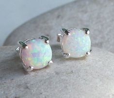 A small pair of Sterling Silver Round Shaped prong set Stud Earring featuring a man-made White Opal, birthstone of October. Wrapped in a box ready for gift giving.(e-stud-205) These lovelies measure 6mm. Matching Ring ----------------------------------------------------- https://www.etsy.com/listing/177260582/opal-ring-silver-opal-ring-silver-ring?ref=shop_home_active_1&ga_search_query=opal%2Bring Matching Necklace as seen in 4th Photo -------------------------------------------------------- htt White Round Stone Earrings For Gift, White Opal Stud Earrings, Boho Silver Earrings, Opal Earring, Opal Stud Earrings, Earrings Opal, Silver Opal Ring, Earring Post, Opal Studs