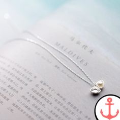 Pearl Necklace In Shell: Exquisite Nautical Elegance Dive into the enchanting world of the sea with our stunning Pearl Necklace In Shell. This exquisite piece captures the beauty and allure of the ocean, making it the perfect accessory for passionate lovers of the sea. Crafted with precision and care, this necklace embodies the essence of nautical elegance. As part of our Shell Necklace collection, the Pearl Necklace In Shell is a true masterpiece. Its timeless design and stunning craftsmanship Elegant Silver Necklace For Beach, Ocean-inspired Pearl Pendant Necklaces As Gifts, Ocean-inspired Pearl Pendant Jewelry, Ocean-inspired Sterling Silver Jewelry For Wedding, Ocean-inspired Sterling Silver Jewelry For Weddings, Elegant Silver Shell Beach Necklace, Elegant Silver Shell Necklace For Beach, Ocean-inspired Pearl Pendant Jewelry As Gift, Ocean-inspired Pearl Charm Jewelry As Gift