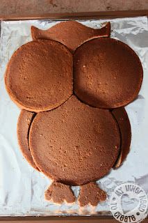 an owl shaped cake sitting on top of a table