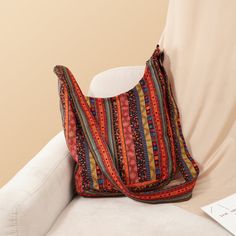 Discover Your New Favorite Accessory Step into the world of timeless style with our Bohemian Vintage Canvas Shoulder Bag. Perfectly blending practicality with artistic flair, this bag is designed for the modern woman who appreciates both form and function. The eye-catching geometric pattern and vintage style fuse to create a statement piece that elevates any outfit. Design and Craftsmanship Made from high-quality canvas with polyester lining, this shoulder bag ensures durability while maintaining a soft and comfortable feel. The spacious interior, featuring a dedicated cell phone pocket, provides ample room for all your essentials. Measuring 34 cm in width and height with a 10 cm thickness, and an adjustable strap that extends up to 125 cm, it offers both style and versatility. Key Feature Bohemian Chic Fashion, Vintage Crossbody Bag, Women Shoulder Bag, Vintage Shoulder Bag, Canvas Crossbody Bag, Canvas Handbags, Vintage Canvas, Crossbody Messenger Bag, Boho Bag