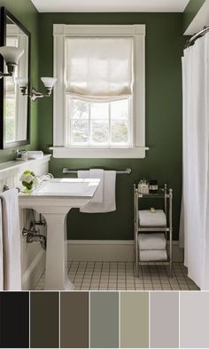 a bathroom with green walls, white fixtures and gray flooring is featured in the color scheme