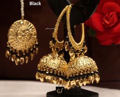 Gold plated high quality jhumka tikka pearl set. Light in weight. *Earrings length: 3.7 inches (with drops) *Circle inner diameter- 1.7 inches *Dome Size: 1.3 inches *Tikka Diameter: 1.4 inches Black Temple Jewelry Earrings For Wedding, Black Round Jhumkas As Gift, Elegant Black Jhumkas With Latkans, Elegant Black Jhumkas For Festive Occasions, Traditional Black Earrings For Wedding, Black Earrings For Wedding And Diwali, Black Danglers With Latkans For Wedding, Black Jhumkas With Latkans As Gift, Black Chandbali Danglers For Party