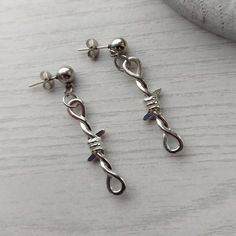 Trendy punk/goth style barbed wire earrings in silver! Unisex Ball studs measure 6mm and are made of stainless steel so are hypoallergenic. Barbed wire charms are made of zinc alloy and measure 34mm in length. Available as a single earring or as a pair. Please don't hesitate to contact me with any queries or suggestions 😊 Comes gift wrapped 💝 Silver Pierced Grunge Earrings, Silver Grunge Pierced Earrings, Grunge Silver Pierced Earrings, Edgy Silver Plug Earrings As A Gift, Edgy Silver Plug Earrings For Gift, Gothic Silver Earrings For Streetwear, Silver Grunge Earrings, Barbed Wire Earrings, Wire Charms