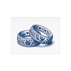 two blue and white wedding rings with hearts on them