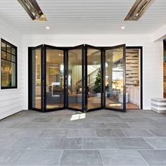 an open room with glass doors and white walls