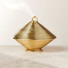 a golden tea pot sitting on top of a table