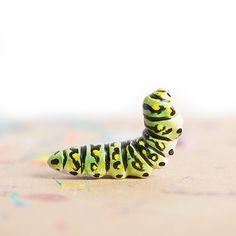 a toy caterpillar sitting on top of a table